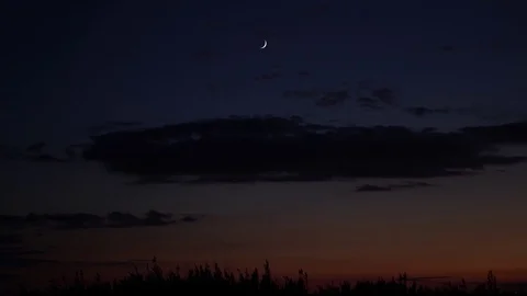 Thin Moon and Clouds Handheld 4K Stock Footage 82170527