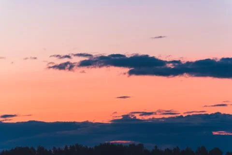 The thin moon rises at dawn among the clouds Stock Photos
