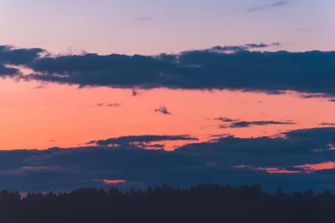 The thin moon rises at dawn among the clouds Stock Photos
