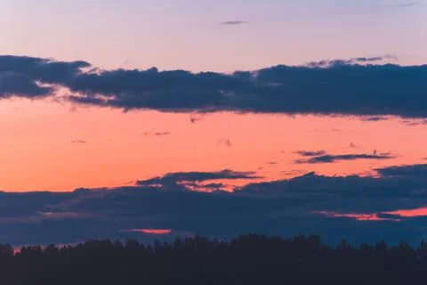 The thin moon rises at dawn among the clouds Stock Photos