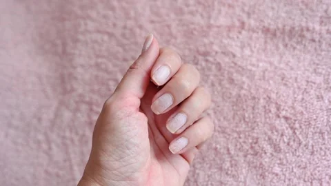 Thin nails damaged after poor quality hardware manicure Stock Footage 143630818