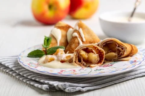 Thin pancakes with apples. Stock Photos