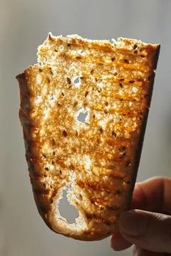 A thin piece of bread. When you hold a thin piece of bread up to a light, t.. Stock Photos