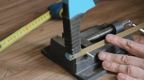 Thin piece of metal being sawed in half Stock Footage 58932763