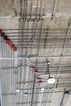 A thin pipe is EMT metal conduit or EMT zinc-plated pipe. Steel plates, eit.. Stock Photos