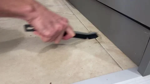 Thin plastic household brush scrubs when cleaning ceramic tile joint Stock-Footage 334191820