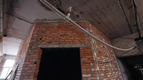 Thin plastic pipe with faucet hanging on the ceiling of a shabby room. Stock Footage 292933727