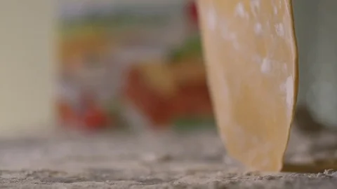 The thin rolled dough falls on the table with flour. Stock Footage 83723713