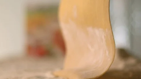 The thin rolled dough falls on the table with flour. Stock Footage 83723737