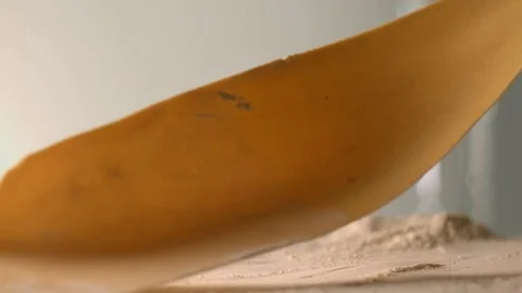 The thin rolled dough falls on the table with flour. Stock Footage 83723878