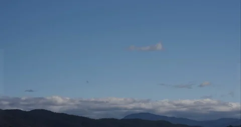 Thin Rolling Clouds Over Mountains Timelapse 4K 스톡 동영상 113896266