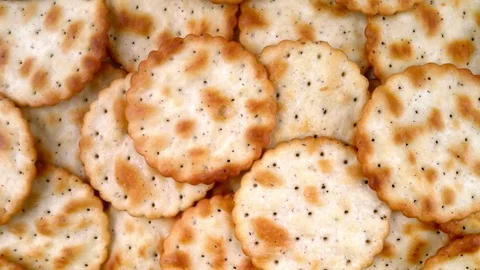 Thin round freshly baked golden brown cracker biscuits Stock Footage 120490591