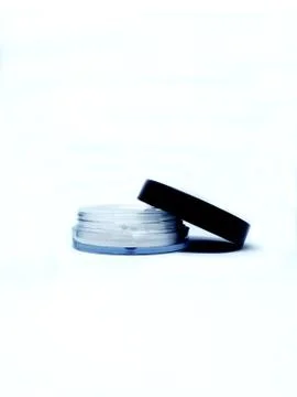Thin round makeup container of white pigment Stock Photos