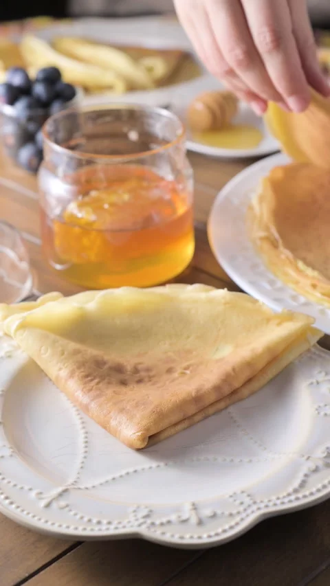 Thin Russian pancakes adorned with fresh berries in this mouthwatering culinary Stock Footage 265619264