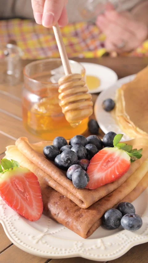 Thin Russian pancakes adorned with fresh berries in this mouthwatering culinary Stock Footage 265619405