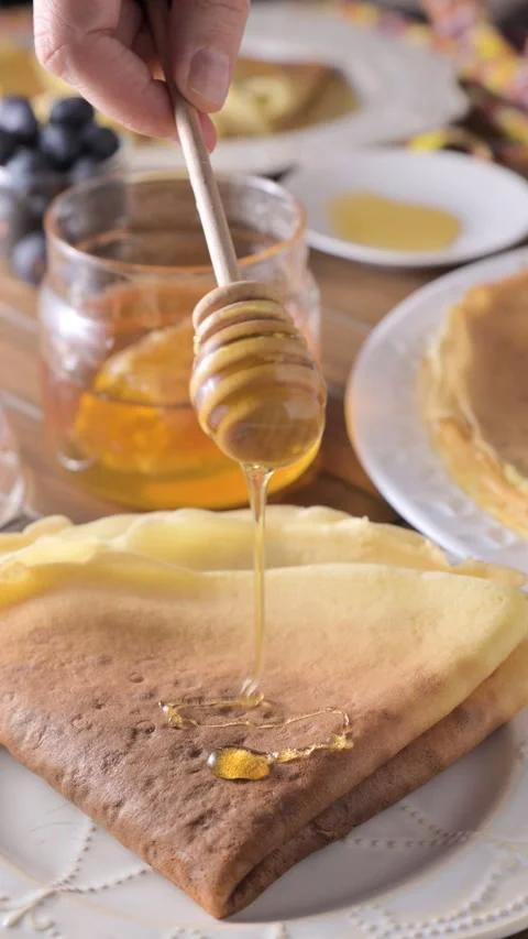 Thin Russian pancakes adorned with fresh berries in this mouthwatering culinary Video stock 274349105