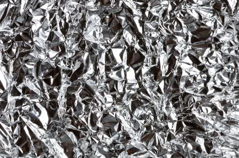 A thin sheet of crumpled silver foil Stock Photos
