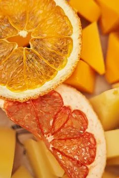 Thin slice of dry orange and grapefruit on mango pieces close-up Stock Photos