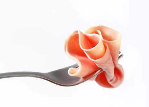 Thin slice of ham on fork - studio shot Stock Photos