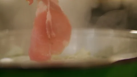 Thin slice pork is put in sukiyaki pot Video stock 101004797