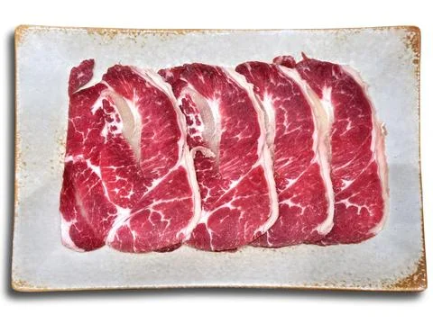 Thin Sliced Ankus Beef on Plate for Barbecue Isolated on White Foto stock
