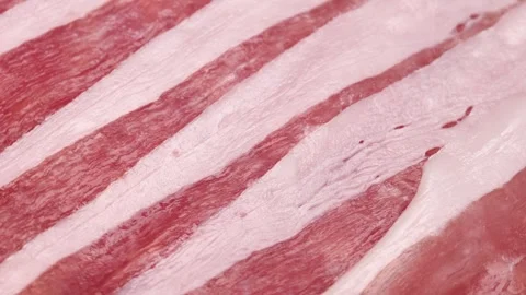 Thin slices of bacon, rotation in circle. Bacon Turning Stock Footage 240664246
