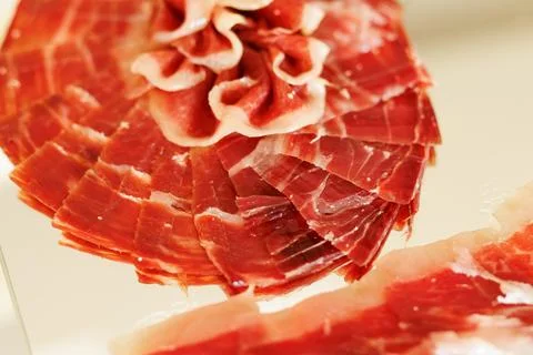 Thin Slices of Cured Ham Arranged in Layered Pattern Stock Photos