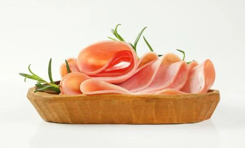 Thin slices of ham with rosemary Stock Photos