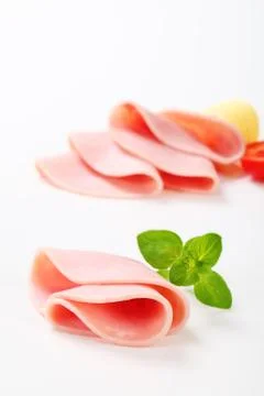 Thin slices of ham on white background Stock Photos