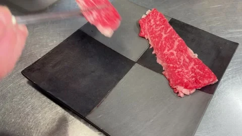 Thin Slices of Marbled Beef on a Black Checkered Plate, Shabu Shabu Wagyu, Japan Stock Footage 346524093