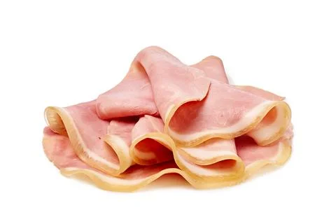 Thin slices of pork ham folded and stacked isolated on white background Stock Photos