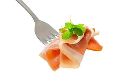 Thin slices of Prosciutto on a fork Stock Photos