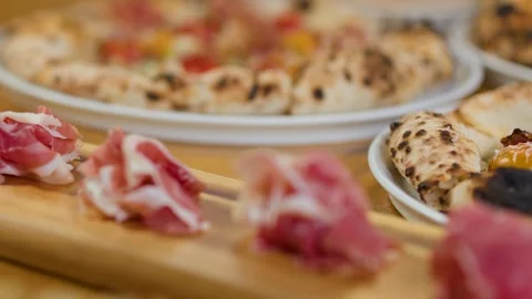 Thin Slices of Prosciutto Ham Served on a Wooden Board Stock Footage 337520021
