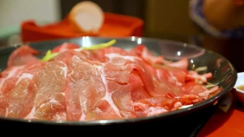 Thin slices of raw beef on a black plate Video stock 333113788
