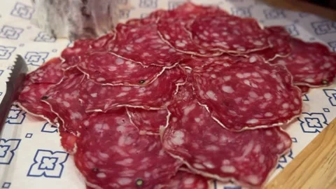 Thin slices of saucisson salami displayed on decorative paper Stock-Footage 314708359