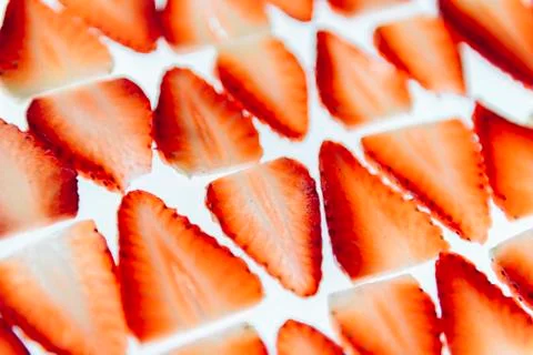 Thin slices of strawberries on white background Stock Photos