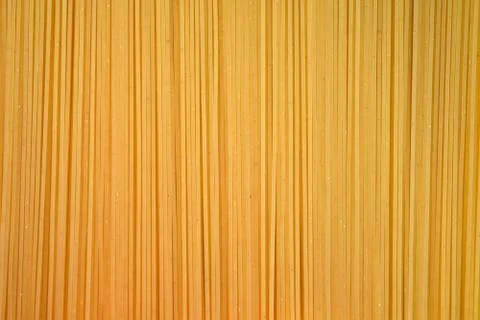 Thin spaghetti closeup top view. Uncooked spaghetti background, flour product Stock Photos
