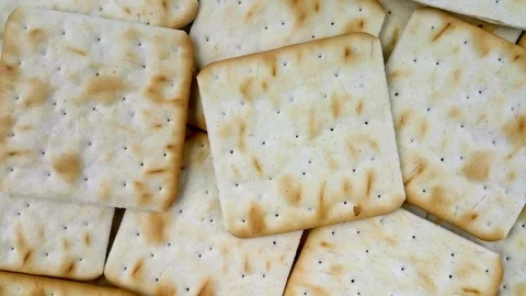 Thin square freshly baked golden brown cracker biscuits Stock Footage 120490429