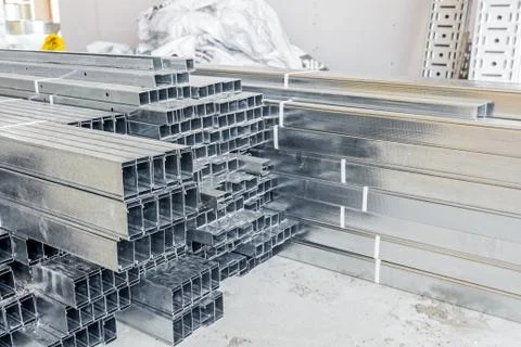 Thin square metal profiles for dry wall stacked on ground Stock Photos