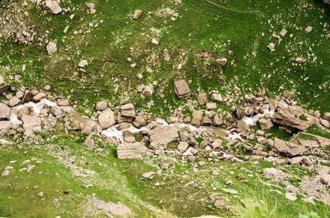 A thin stream between the stones. Stock Photos