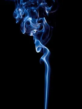 A thin stream of blue smoke curls and rises spectacularly Stock Photos