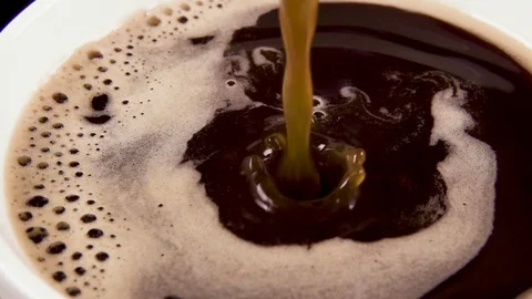 A thin stream of coffee in a white cup slow motion Video stock 90782930