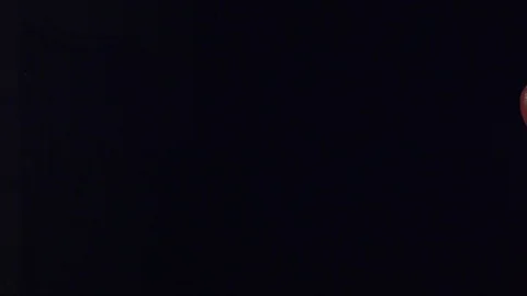 Thin stream of red fluid splashing and pouring across screen in slow motion C Stock Footage 109572175