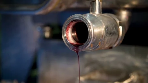 A thin stream of red wine flows out of the tank crane Stock Footage 99104458