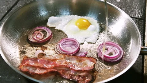 A thin stream of vegetable oil flows into a hot pan. Stock Footage 101751368