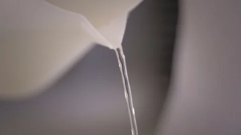 Thin stream of water poured carefully Stock Footage 76558707