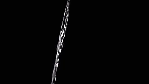 Thin Stream Of Water Pouring On Black Background. Close-up Stock Footage 312013209