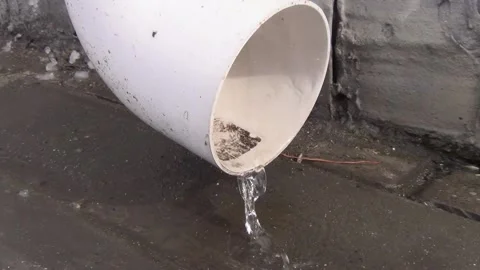 A thin stream of water pours from the drain pipe Stock Footage 148101523