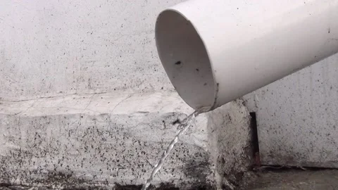 A thin stream of water pours from the drain pipe Stock Footage 148101577