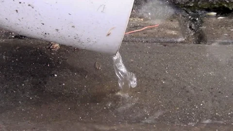A thin stream of water pours from the drain pipe Stock Footage 148102493